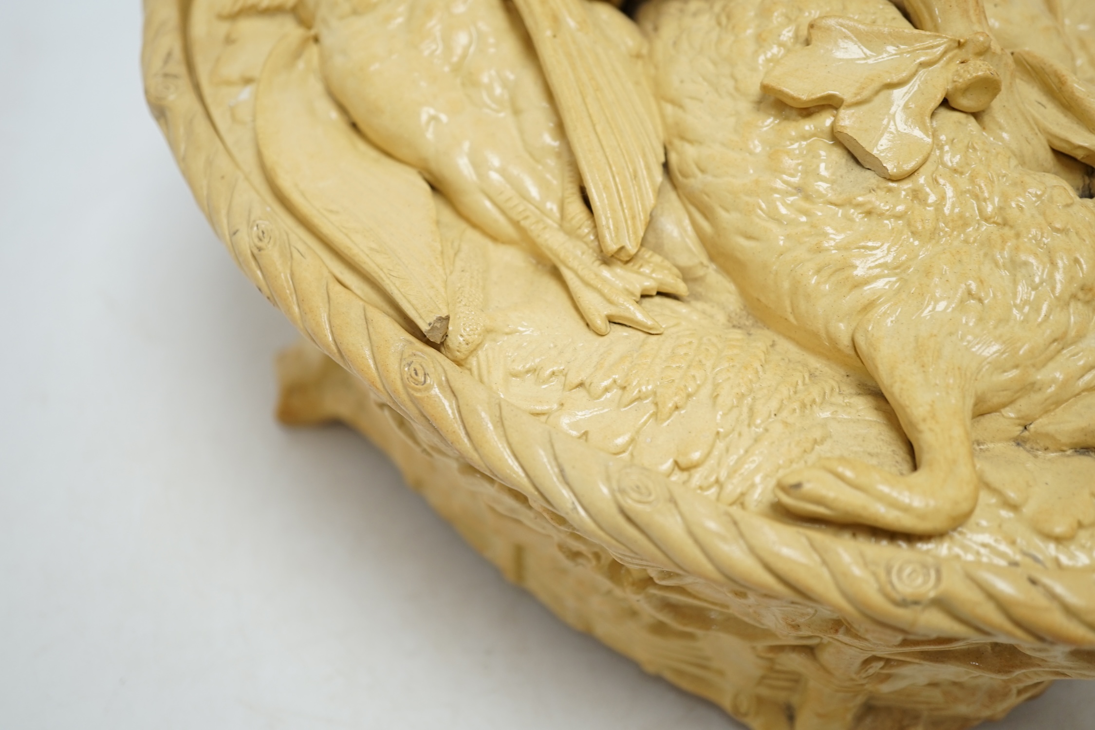 A 19th century Minton caneware game pie dish and cover, 33cm wide. Condition - acorn leaf tip and wing tip missing on cover, small chips to inner lip of tureen.
